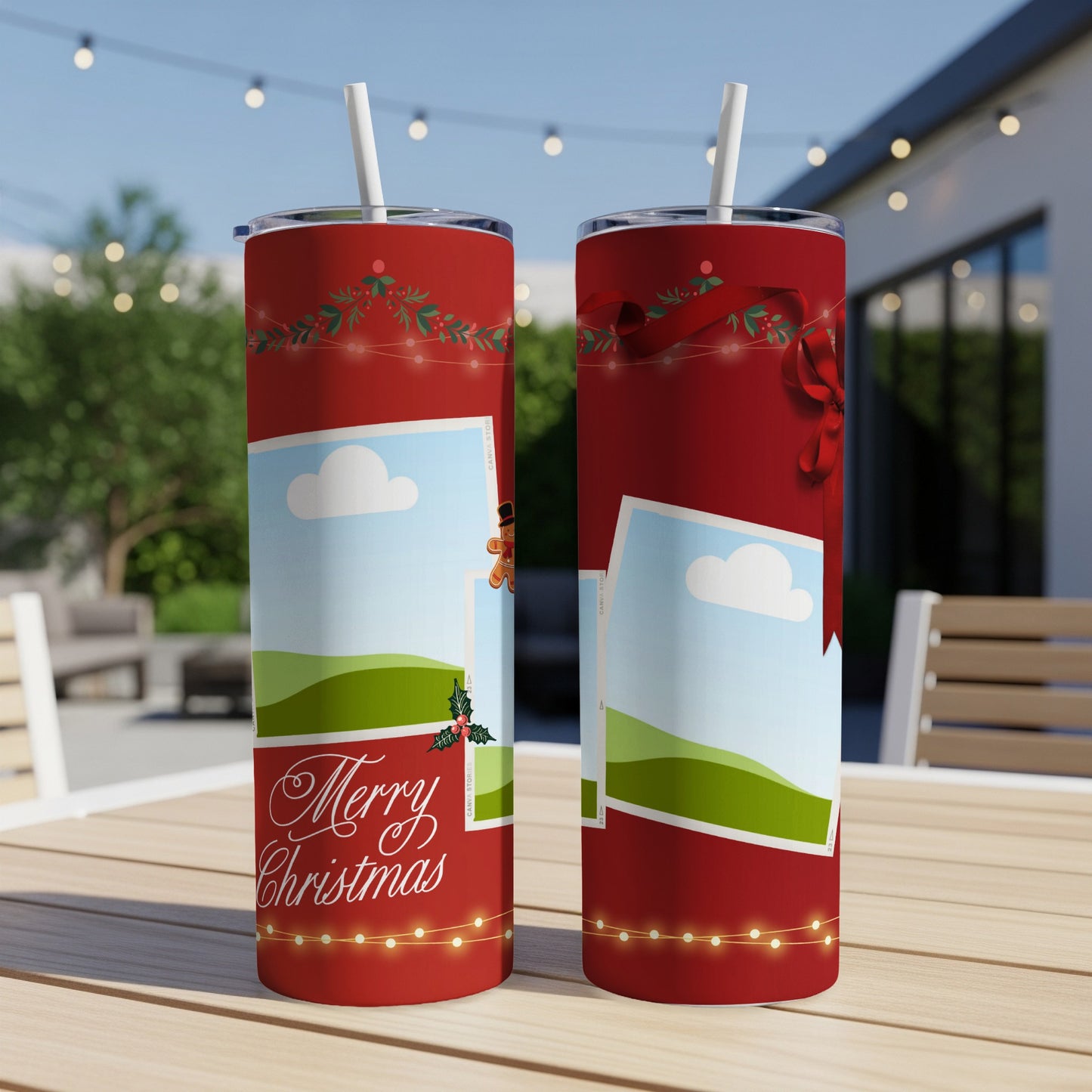 Two red tumblers with Christmas designs and straws sit on a table outdoors.