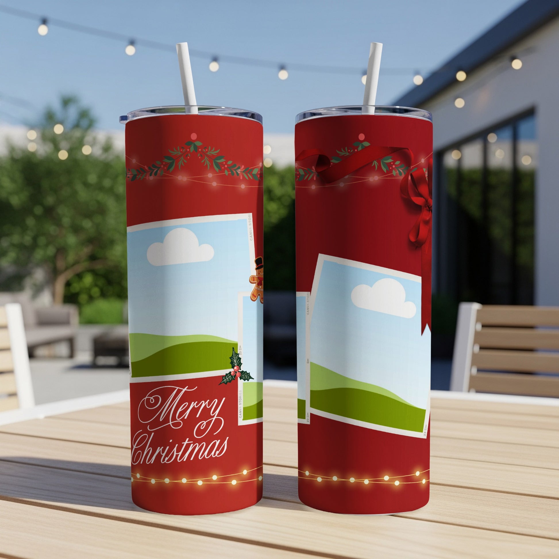 Two red tumblers with Christmas designs and straws sit on a table outdoors.