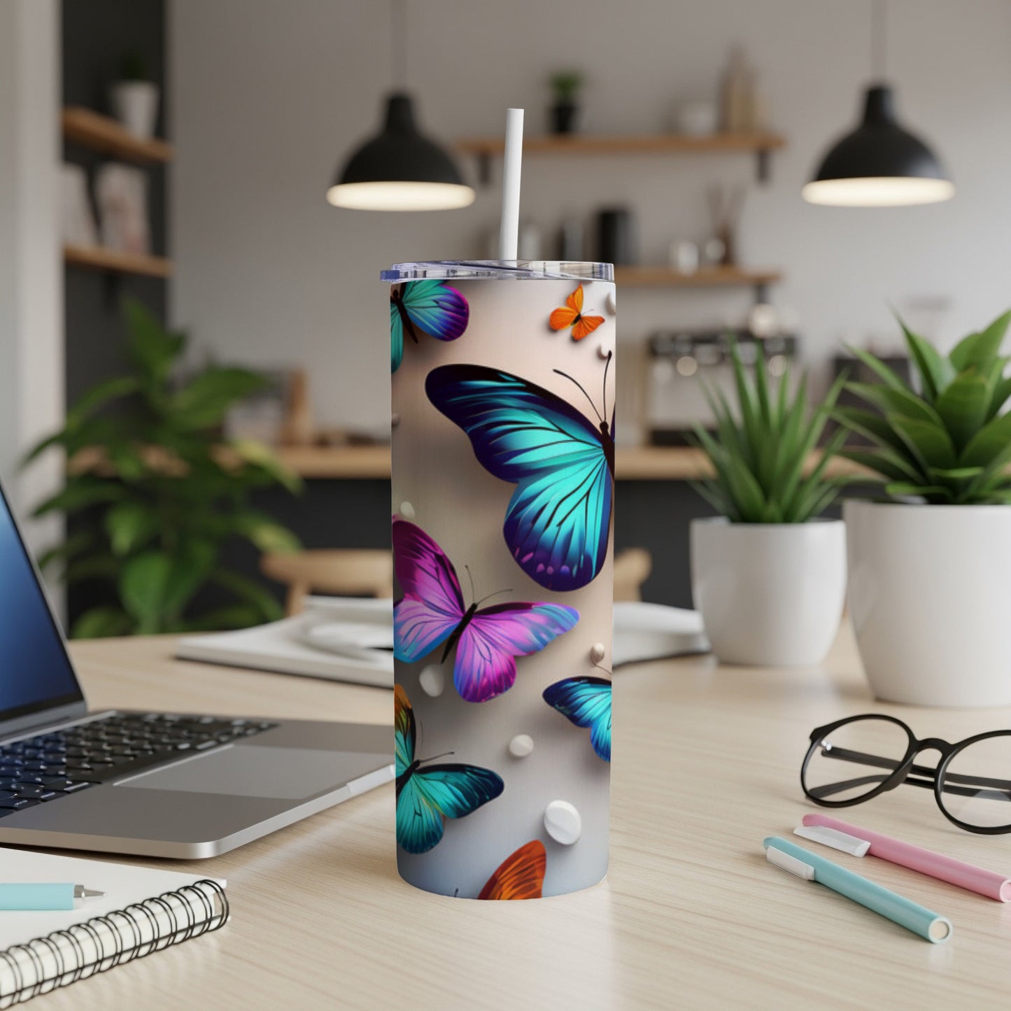 Tumbler with colorful butterfly and floral design, straw in lid.