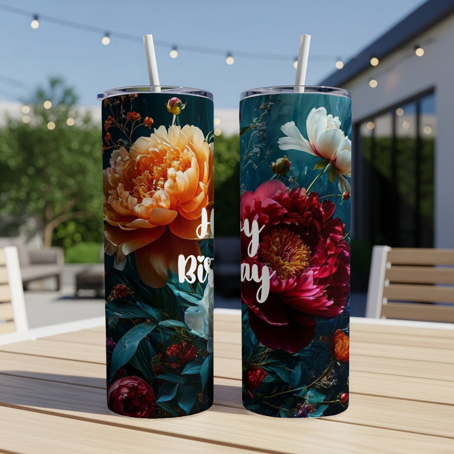 Two tumblers with floral designs and "Happy Birthday" text on a table.