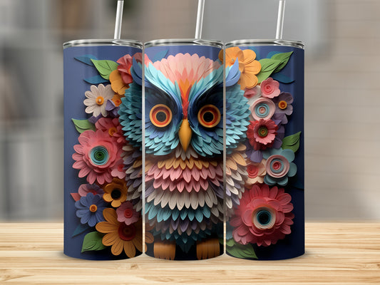 3D owl surrounded by colorful flowers on a navy blue tumbler.