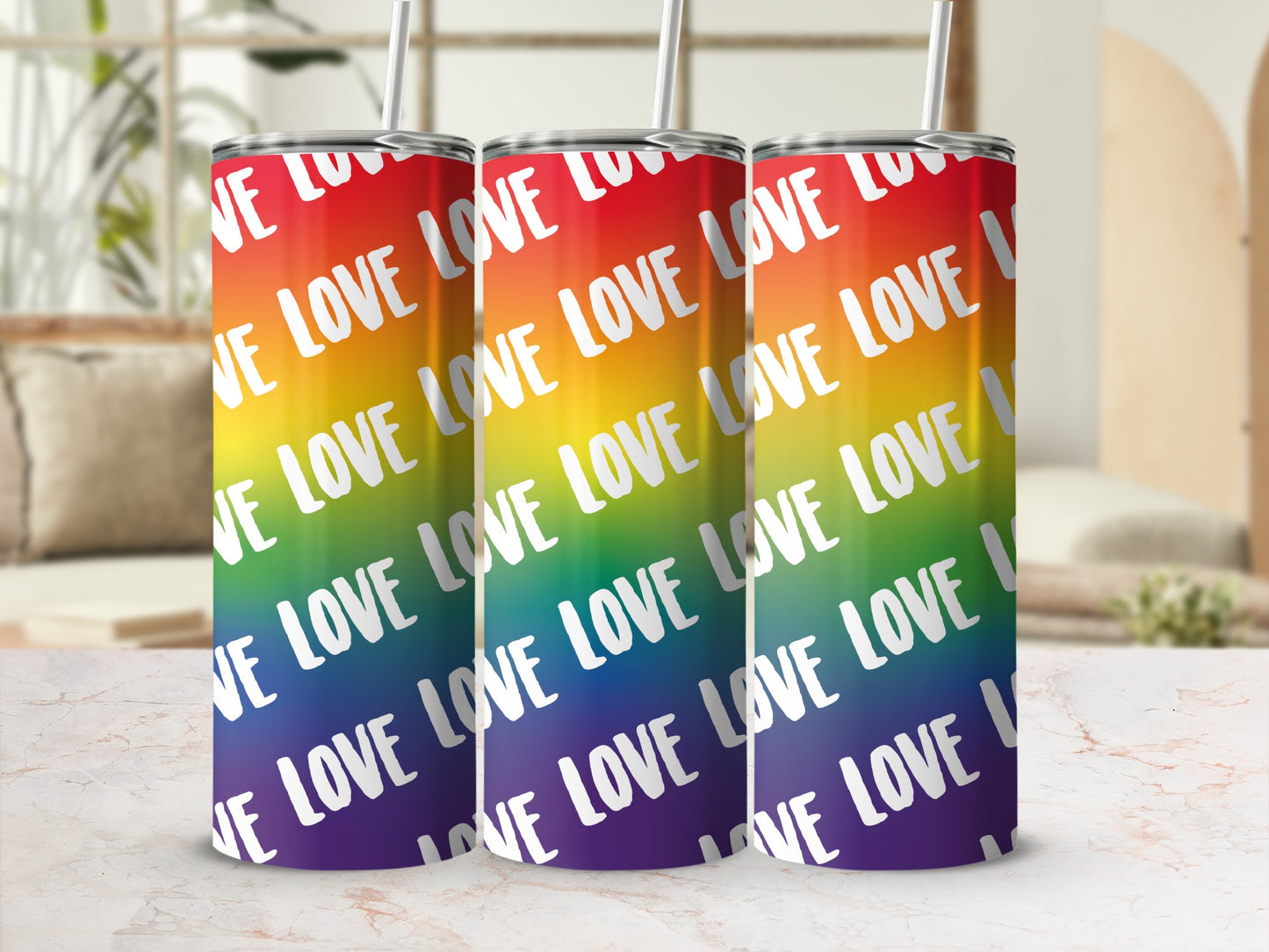 Three rainbow tumblers with "LOVE" text repeated across them.