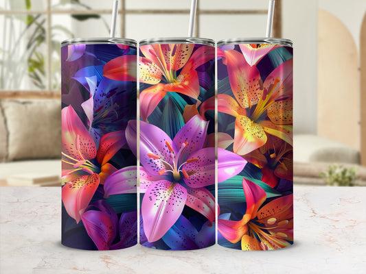 Three tumblers with vibrant lily flower patterns on a marble surface.