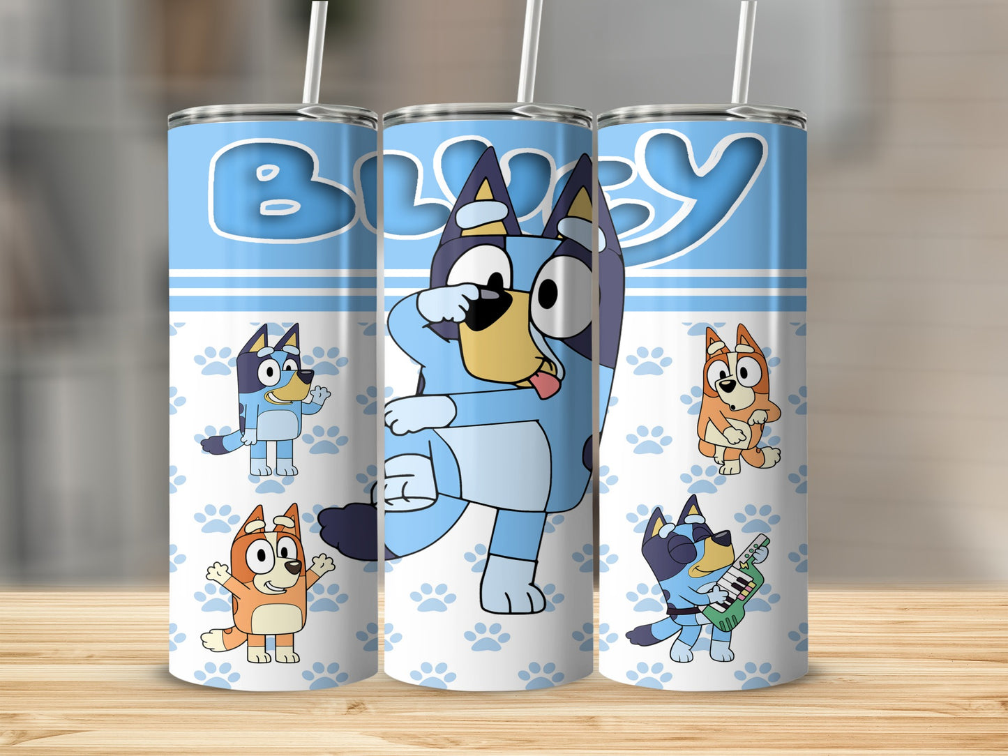 Bluey characters on a blue and white paw print background tumbler.