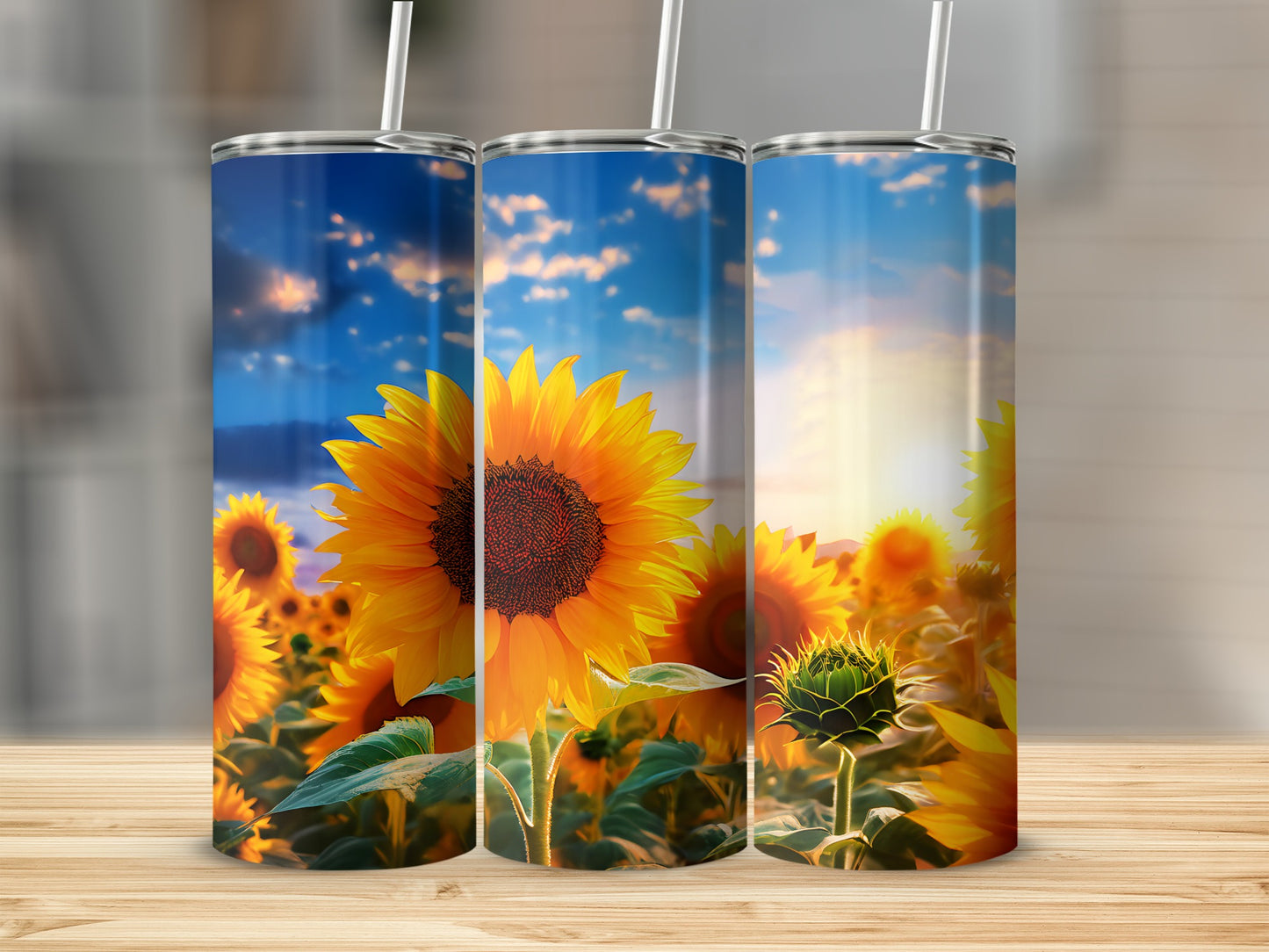 Three tumblers with a sunflower field under a sunset sky.