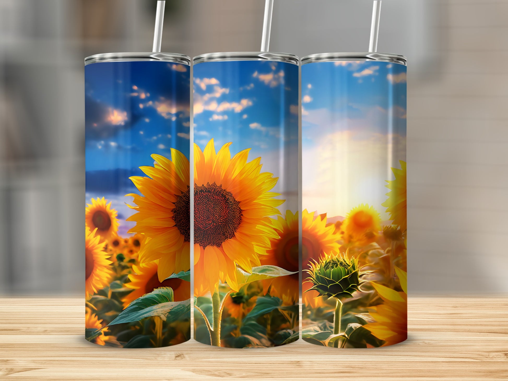 Three tumblers with a sunflower field under a sunset sky.