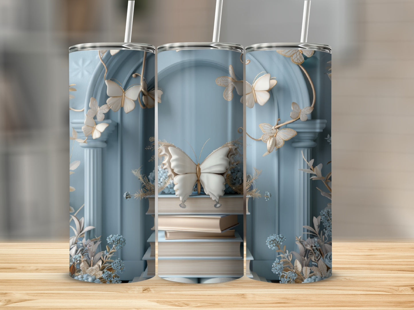 Three tumblers with a pale blue background and delicate butterfly and floral designs.