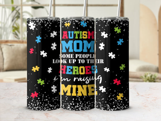 Autism Mom tumbler with puzzle pieces and "Some People Look Up To Their Heroes In Raising Mine".