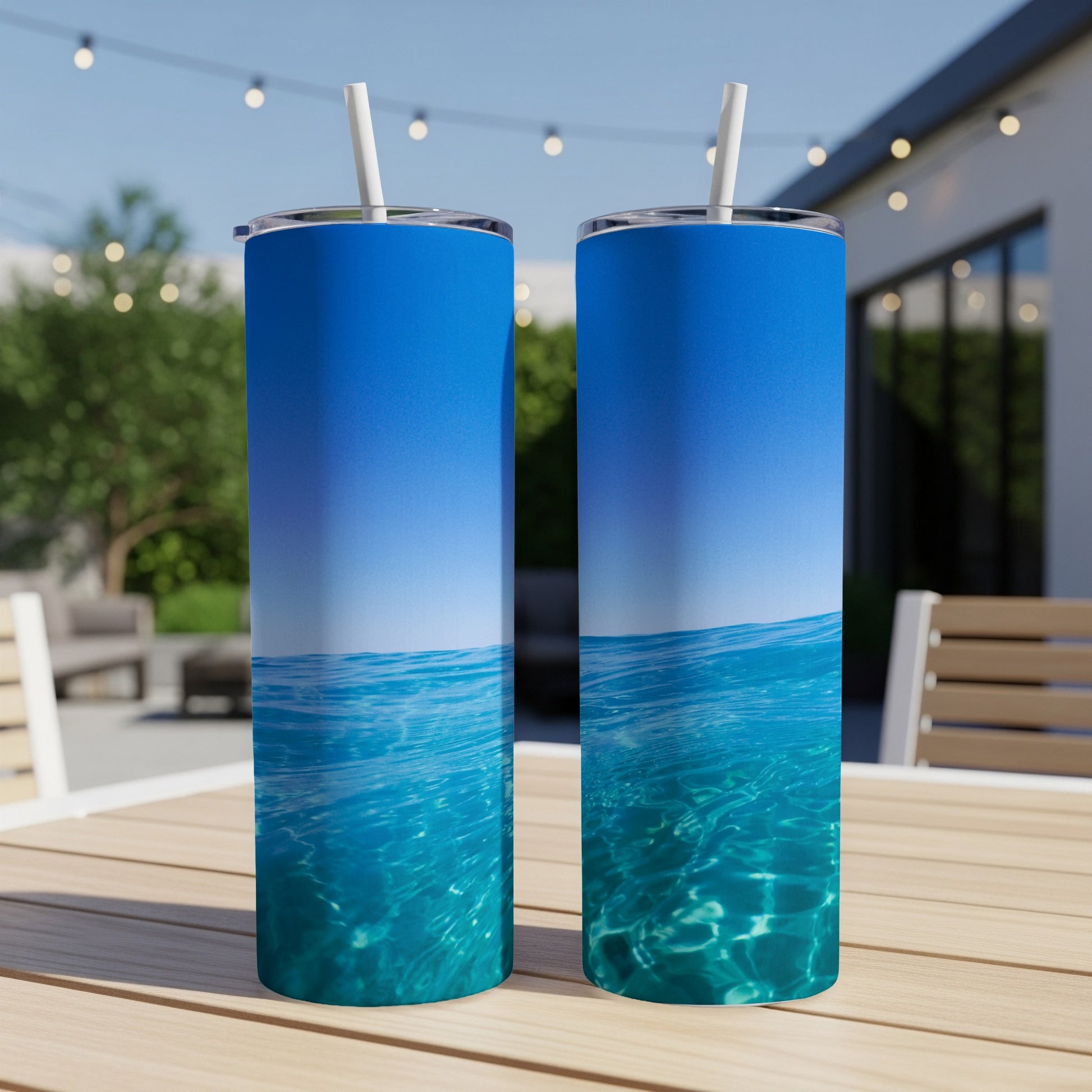 Two tumblers with a clear blue water and sky design.