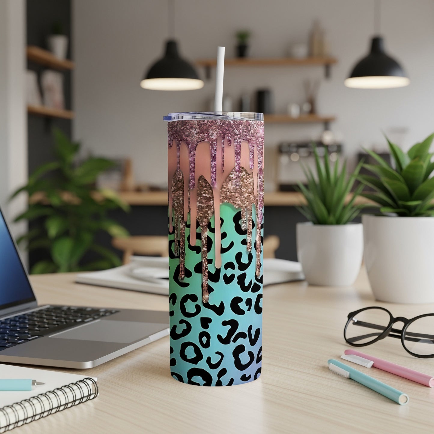 Glitter-drip tumbler with teal and black leopard print.