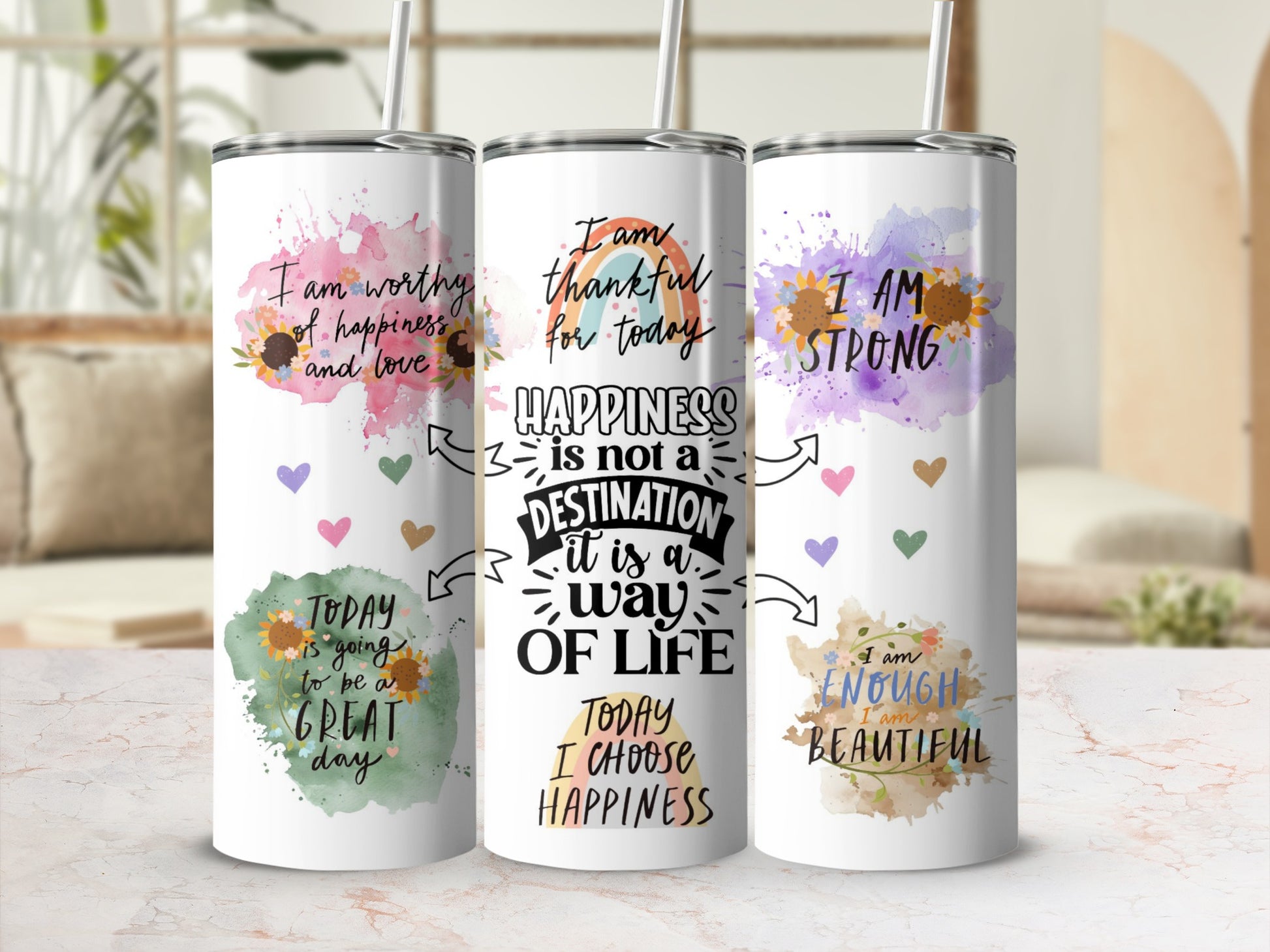 Three tumblers with motivational quotes and watercolor floral designs.