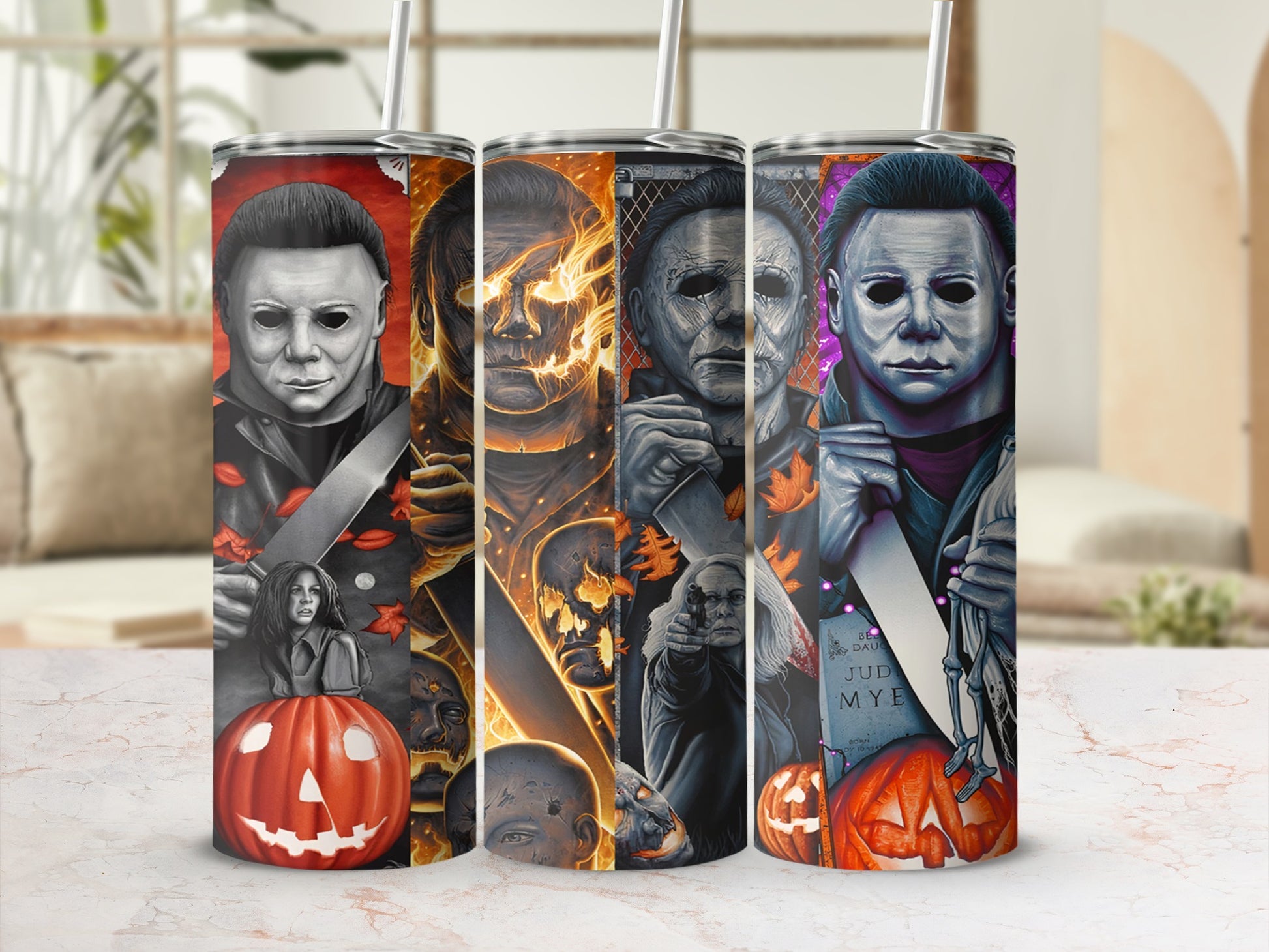 Michael Myers artwork on three tumblers with pumpkins and spooky imagery.