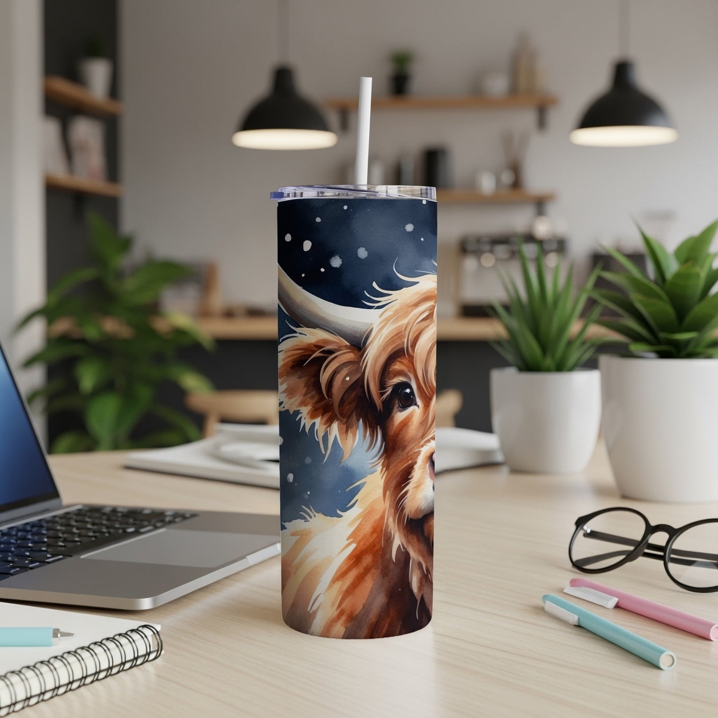 Watercolor highland cow on a navy starry background on a tumbler.