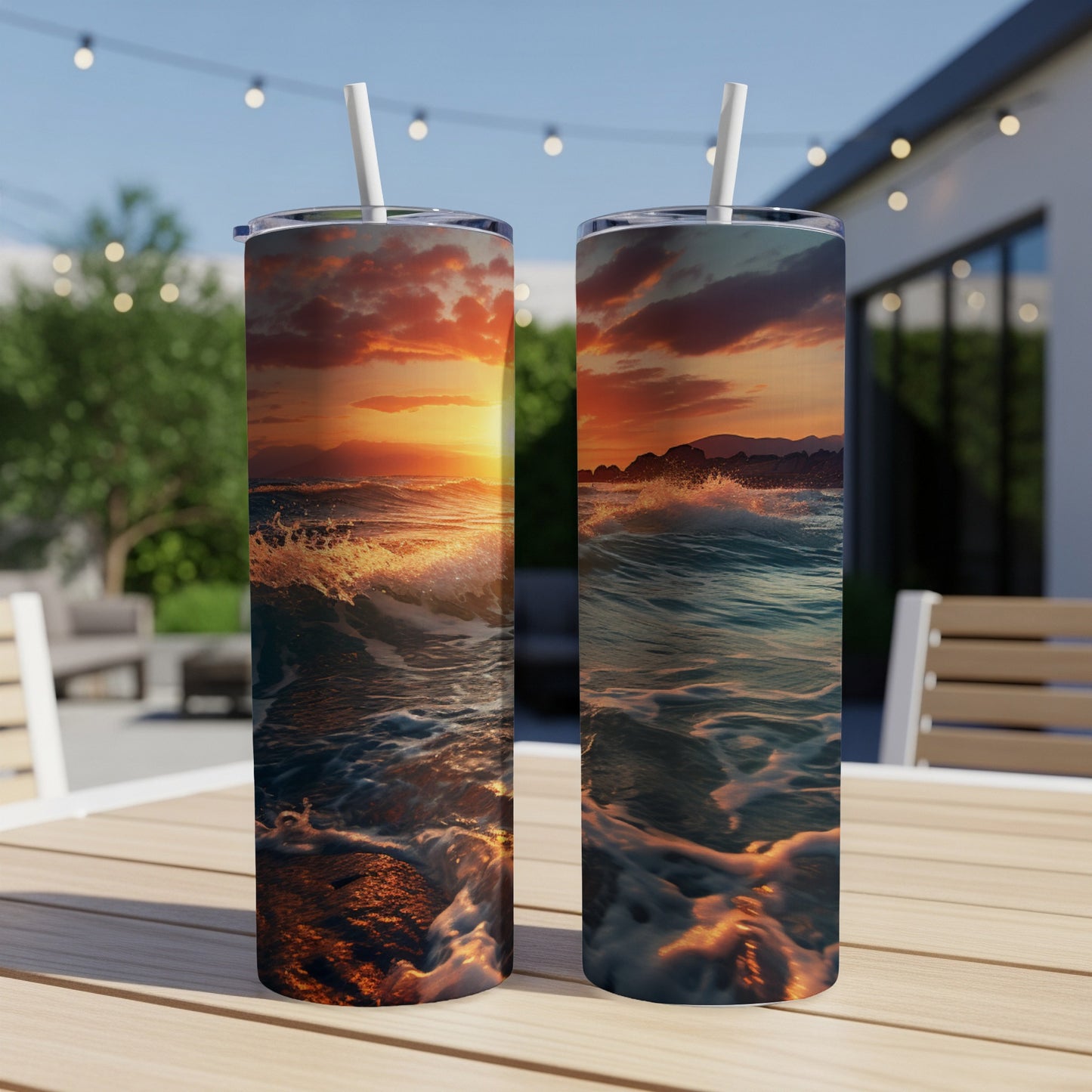 Two tumblers with sunset ocean wave art on a wooden table.