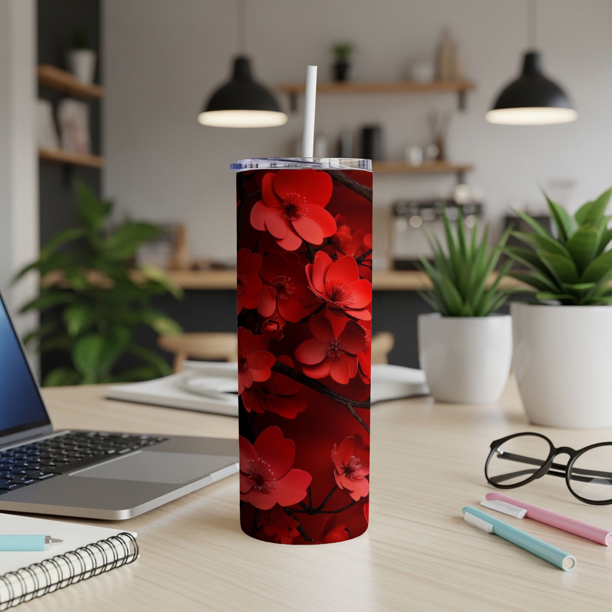 Red floral pattern on a tall tumbler with a white straw.