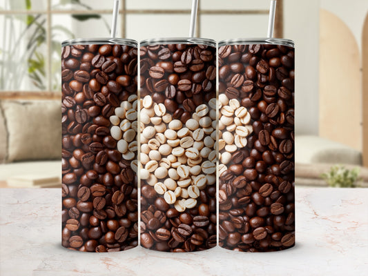 Three tumblers showcasing a coffee bean heart design against a blurred background.