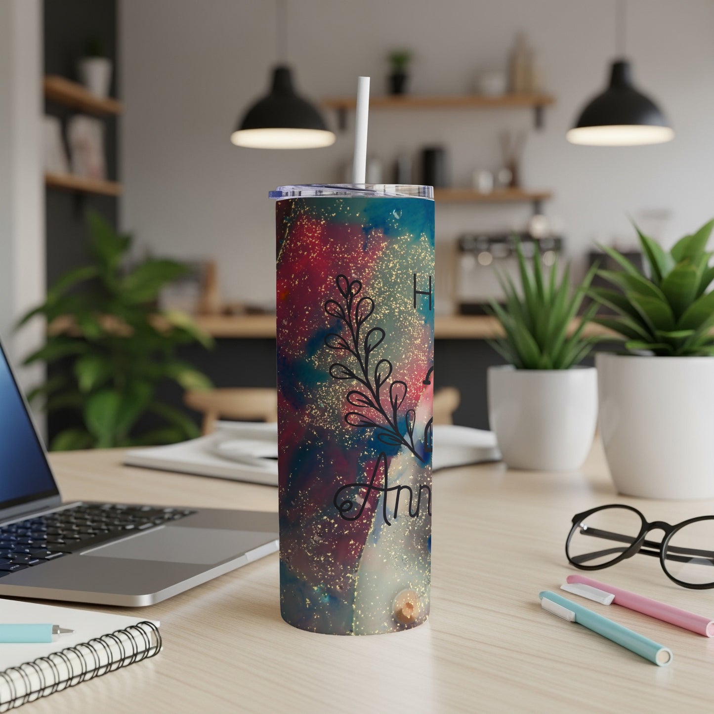 Glittery tumbler with "Happy Anniversary" text on a desk.