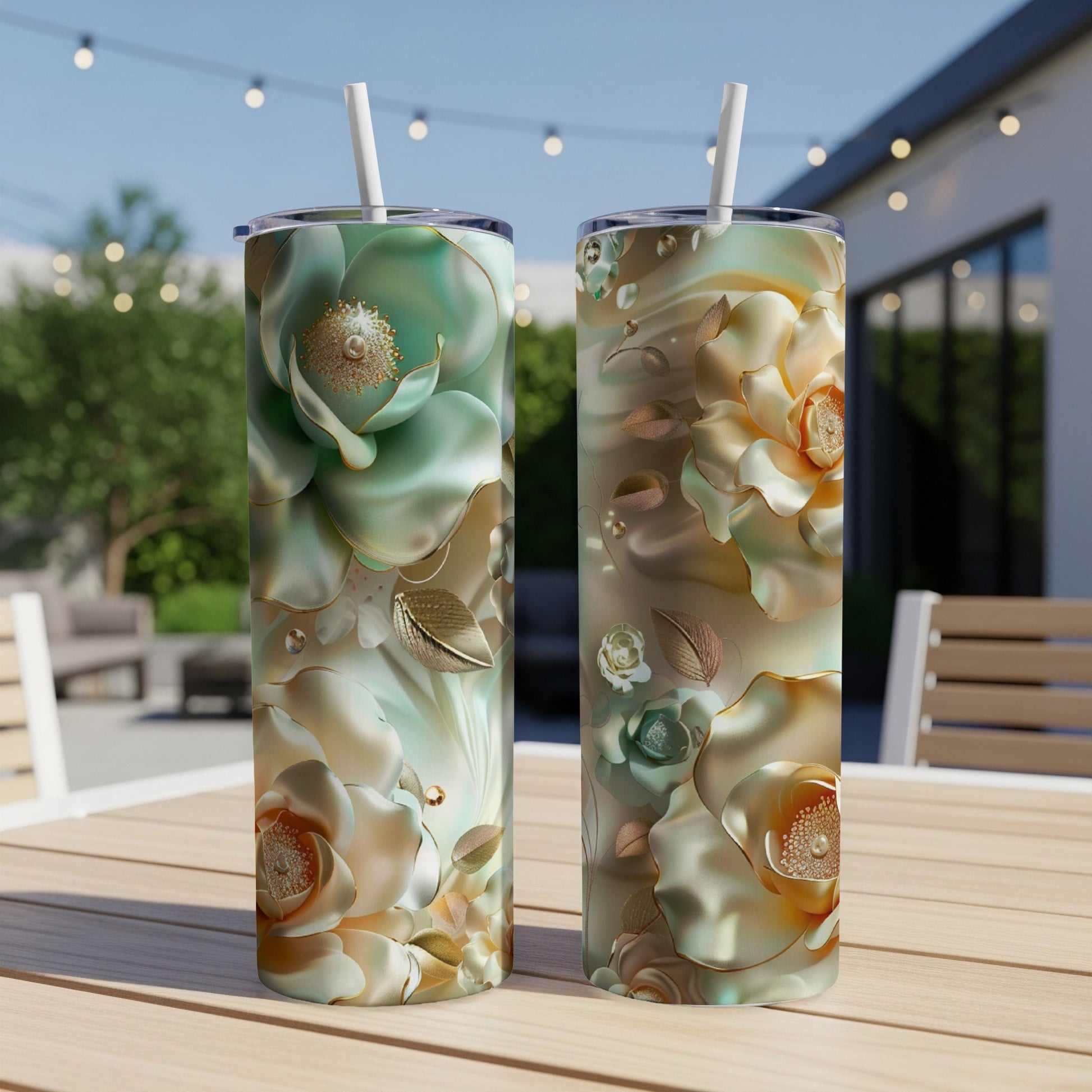 Two tall tumblers with floral designs on a wooden table.