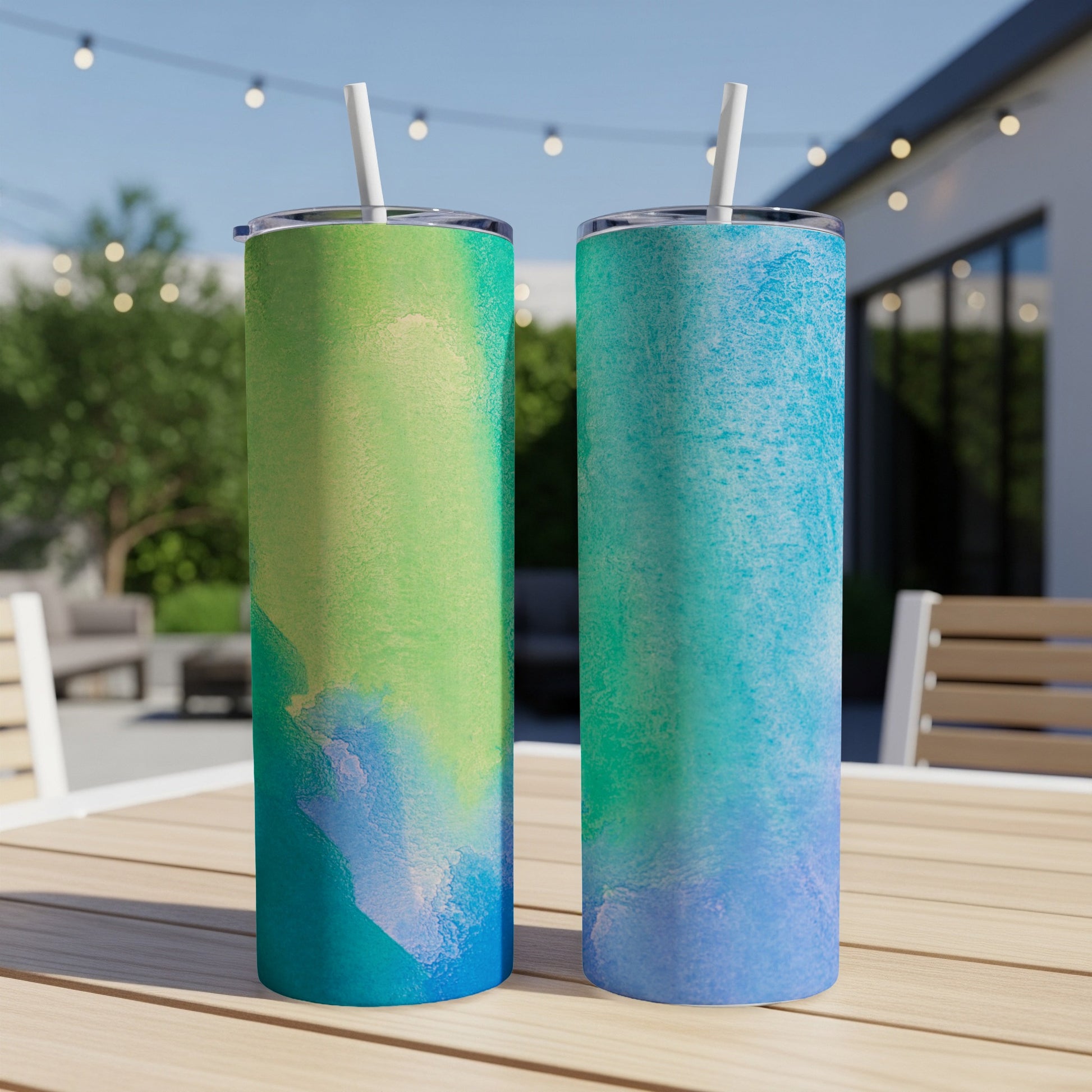 Two tall tumblers with abstract blue and green watercolor designs.