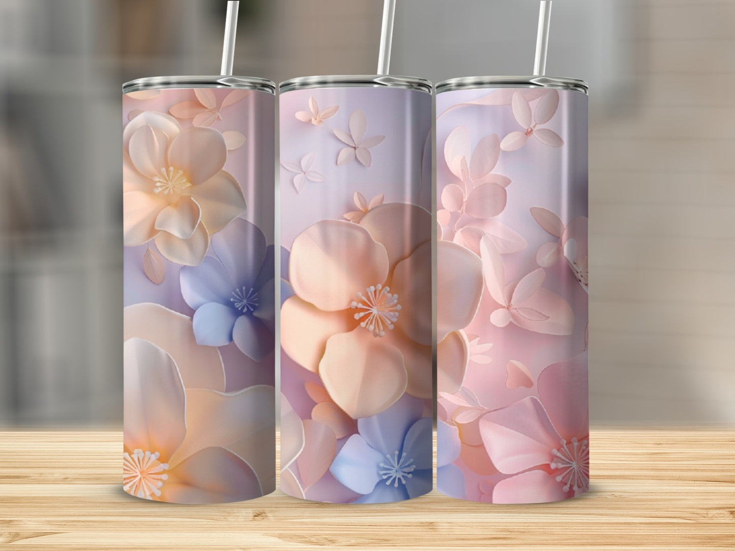 Three tumblers with pastel floral designs, featuring delicate petals and butterflies.