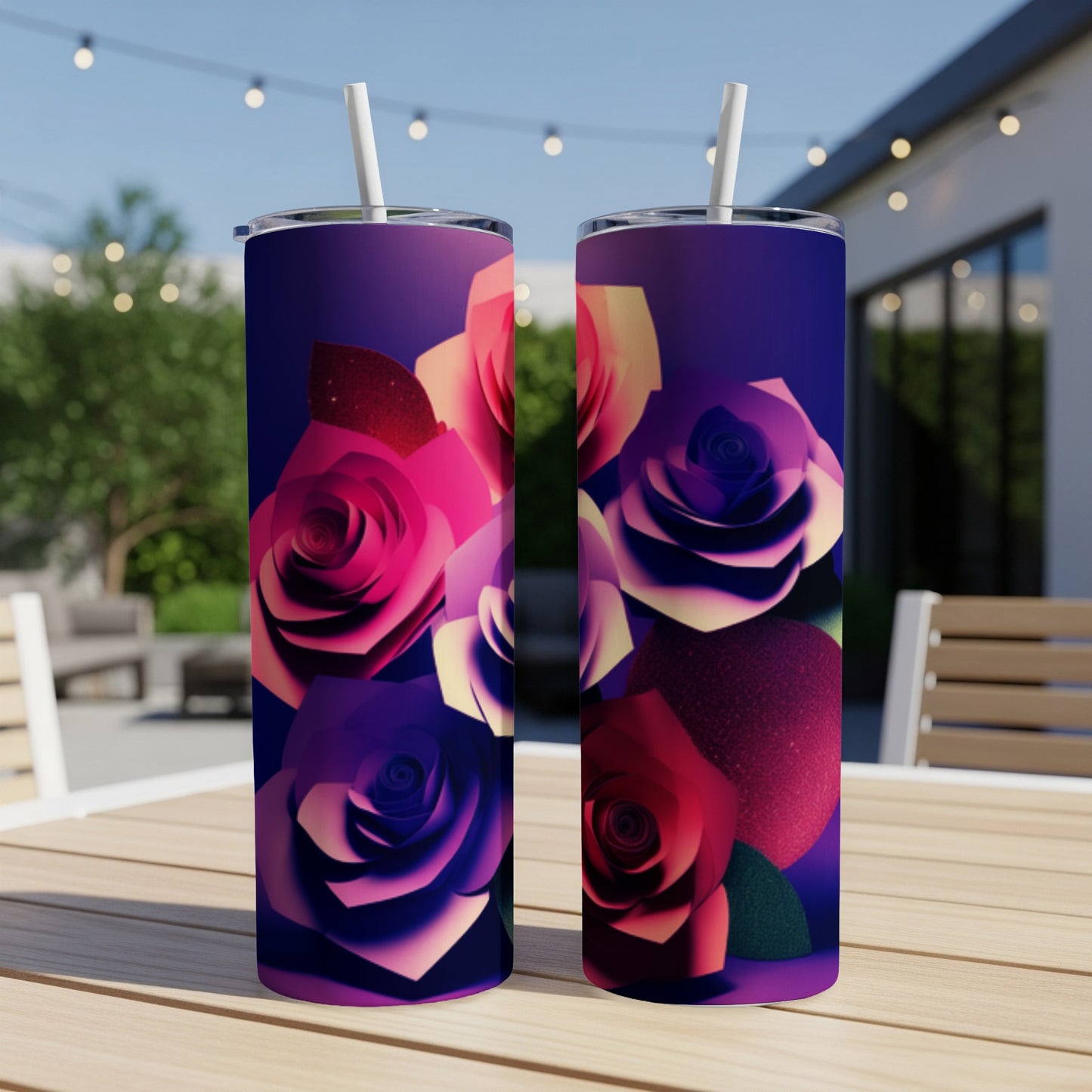 Two tumblers with floral rose designs sit on a wooden table.