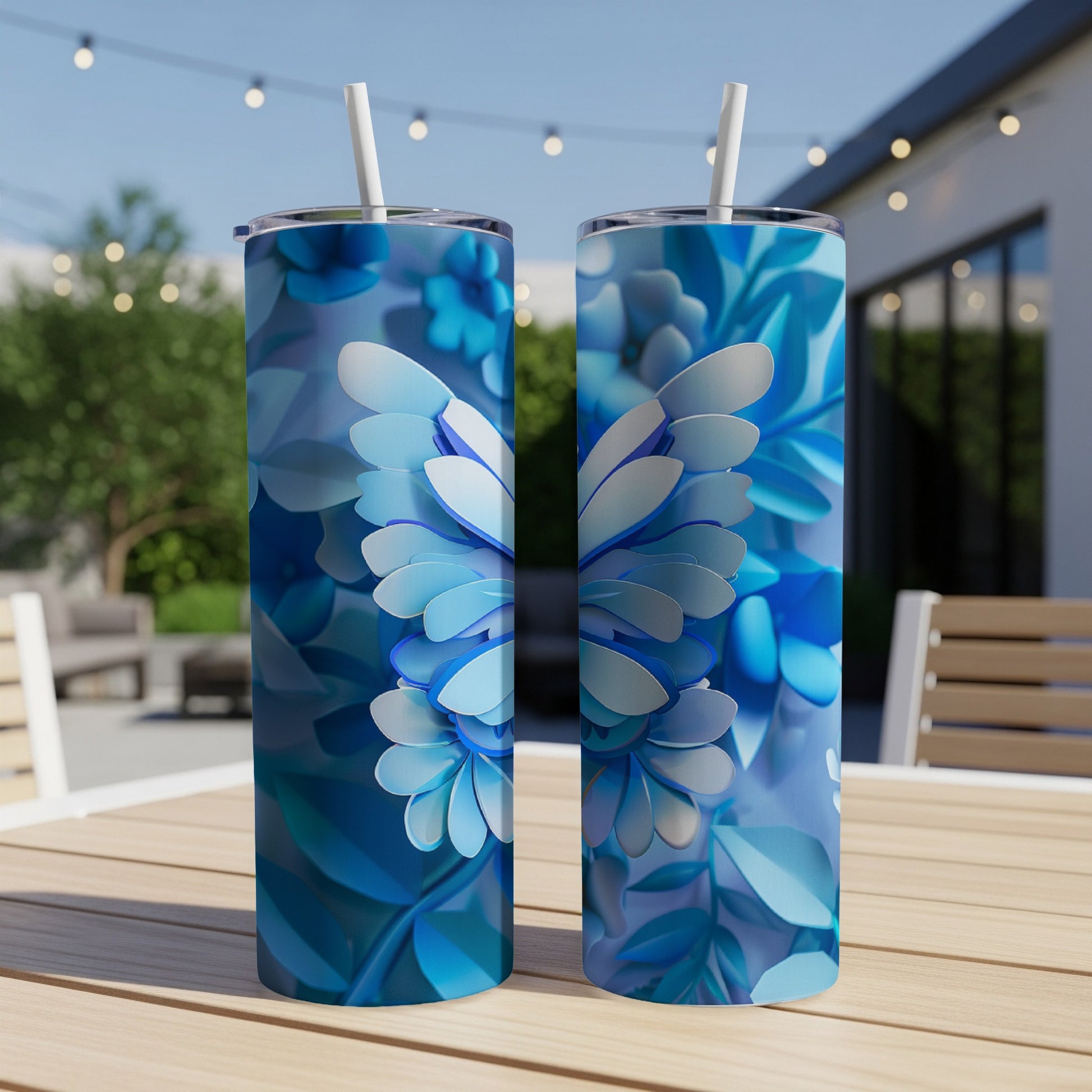 Two blue floral butterfly pattern tumblers on a wooden table.