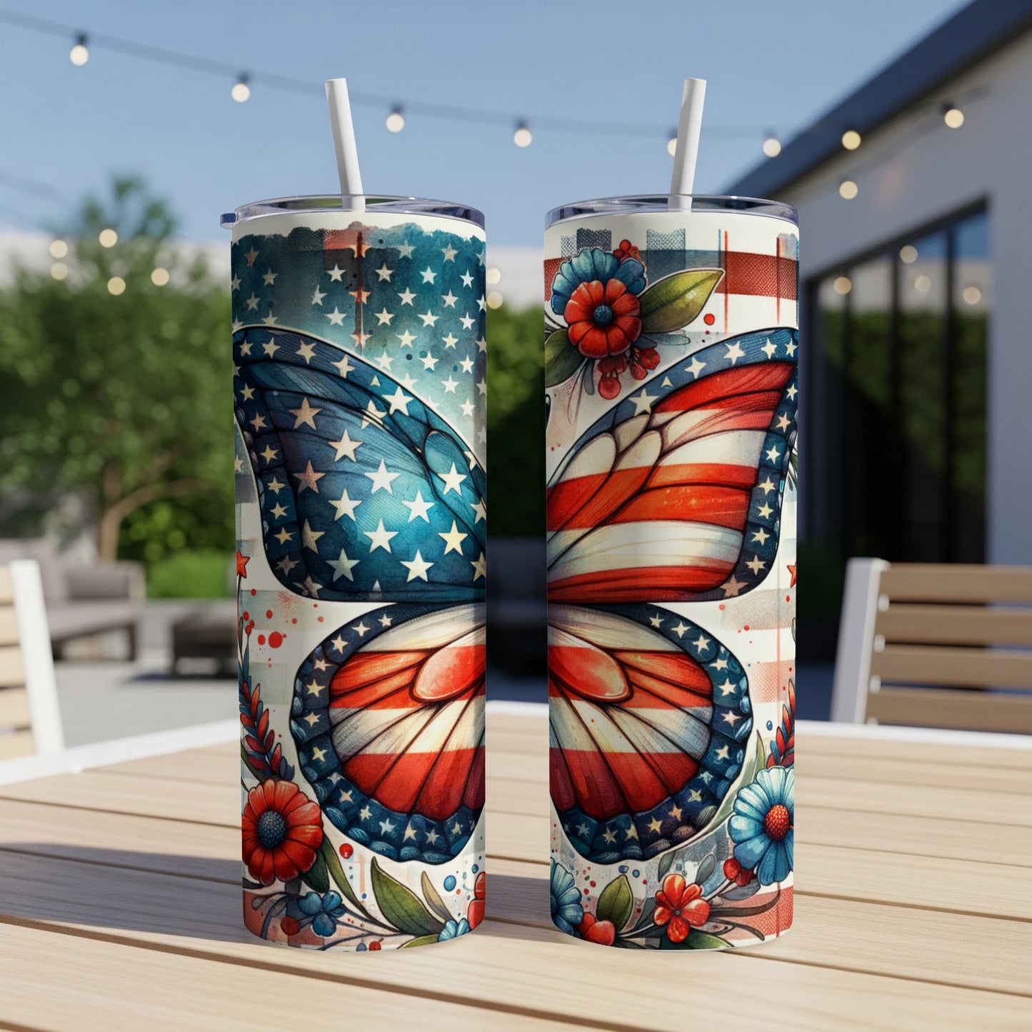 Two patriotic butterfly-themed tumblers with straws on a wooden table.