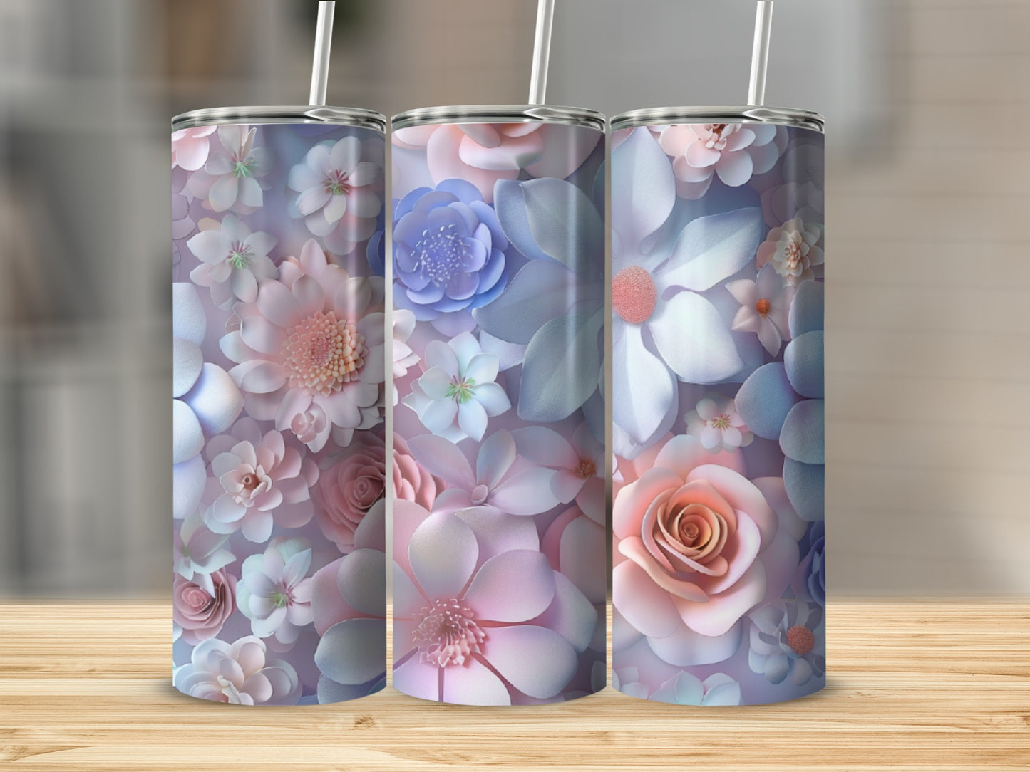 Three tumblers with pastel floral designs and white straws.