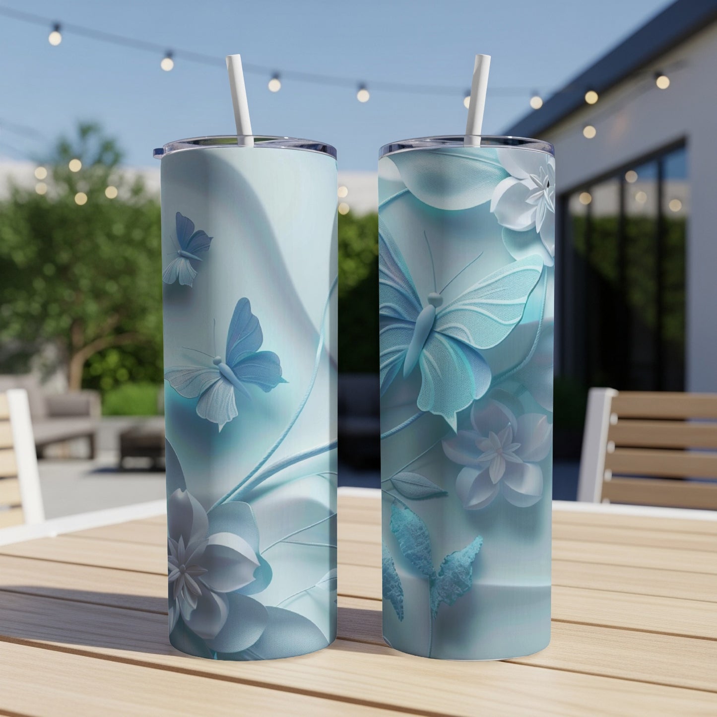 Two tall, slim tumblers with a blue butterfly and floral design.