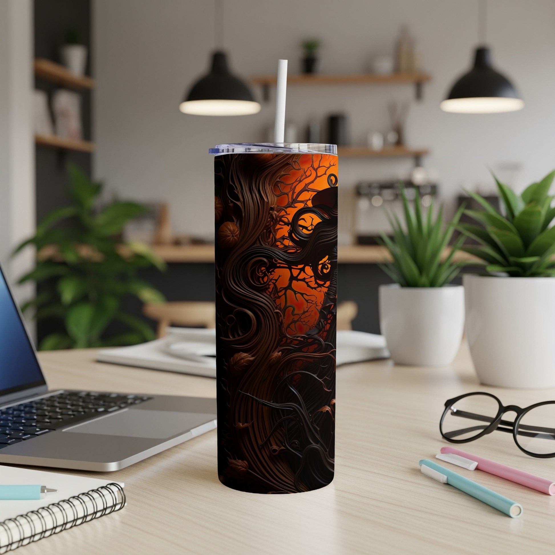 Halloween tumbler with spooky tree, pumpkin, and bat design against orange background.