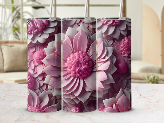 Three pink floral tumblers with straws displayed on a marble surface.