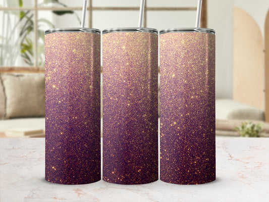 Three glittery purple and gold tumblers with straws on a marble surface.