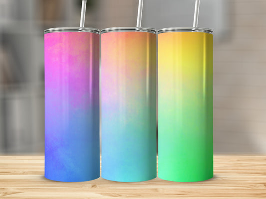 Three tall tumblers with gradient colors on a wooden surface.