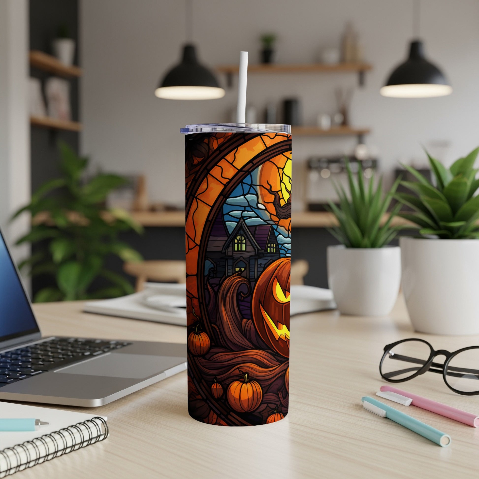 Tumbler with Halloween theme featuring a jack-o'-lantern, haunted house, and moon.
