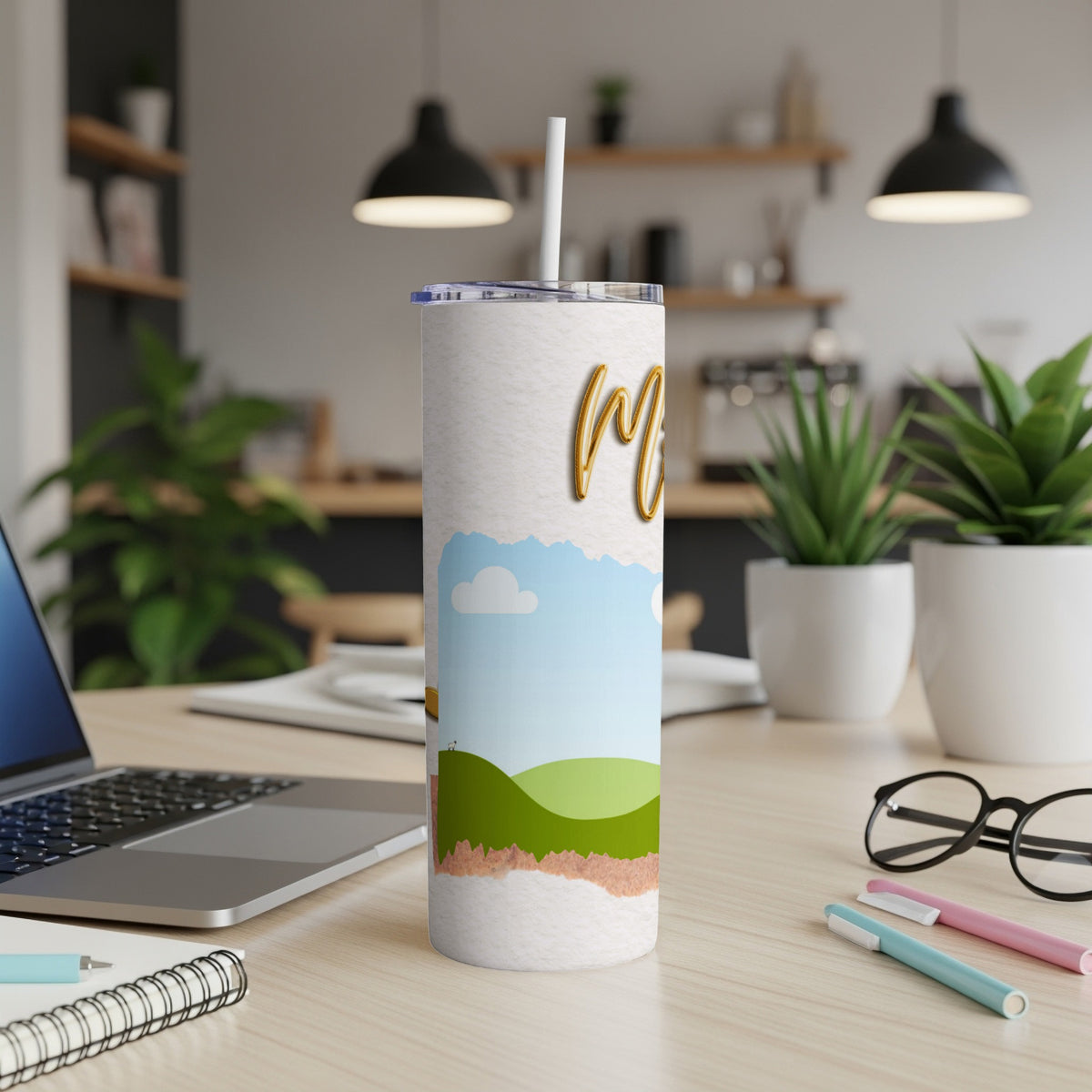 Tumbler with gold "Mom" text and a green rolling hills landscape design.