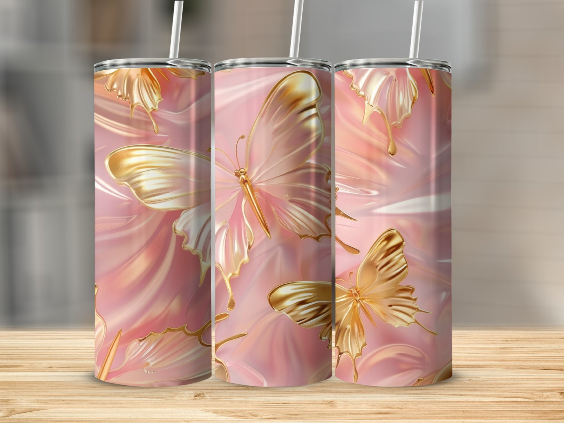 Three golden butterflies with pink marbled background on tumblers.