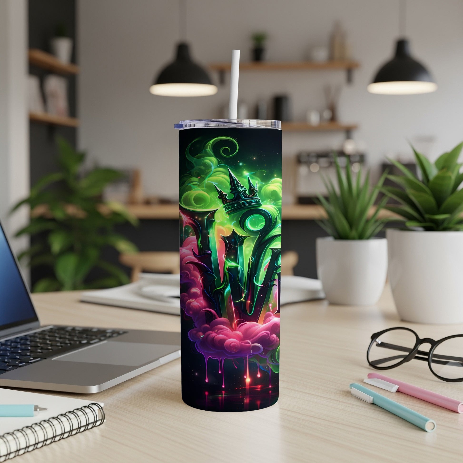 Black tumbler with vibrant green and pink abstract design and a white straw.