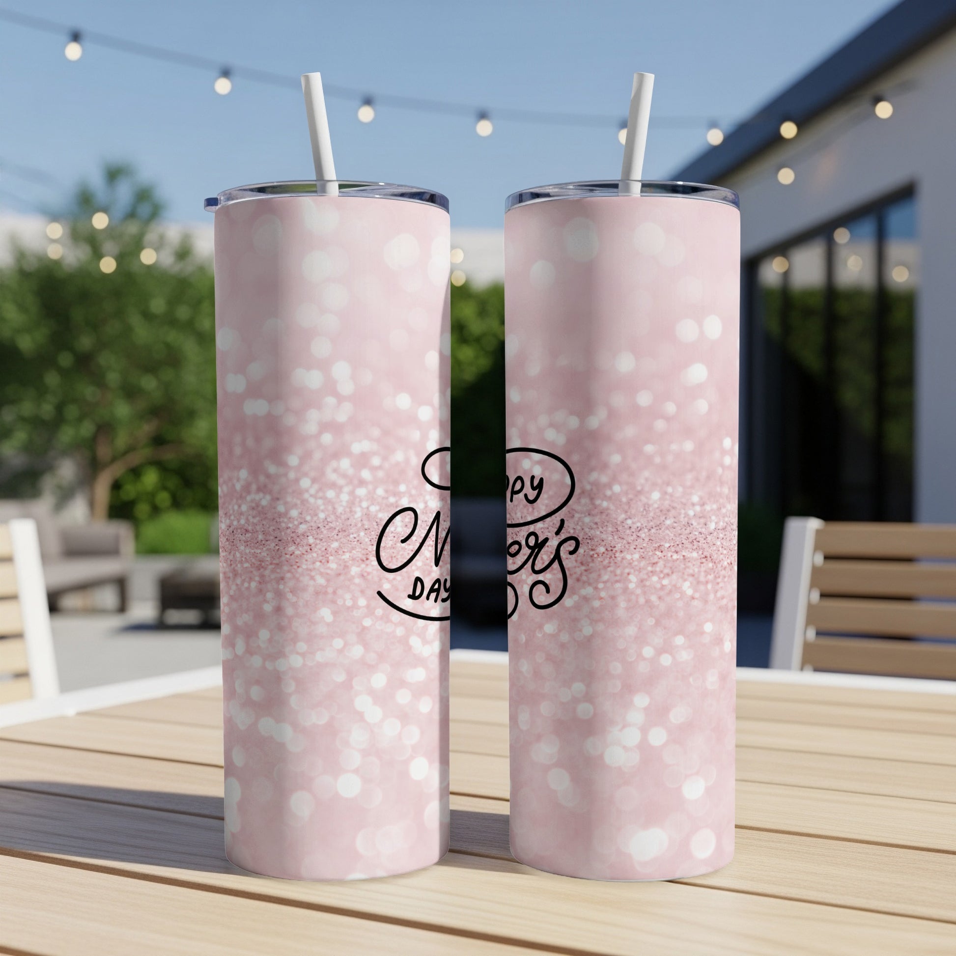 Pink glitter tumbler with "Happy Mother's Day" text on a table.