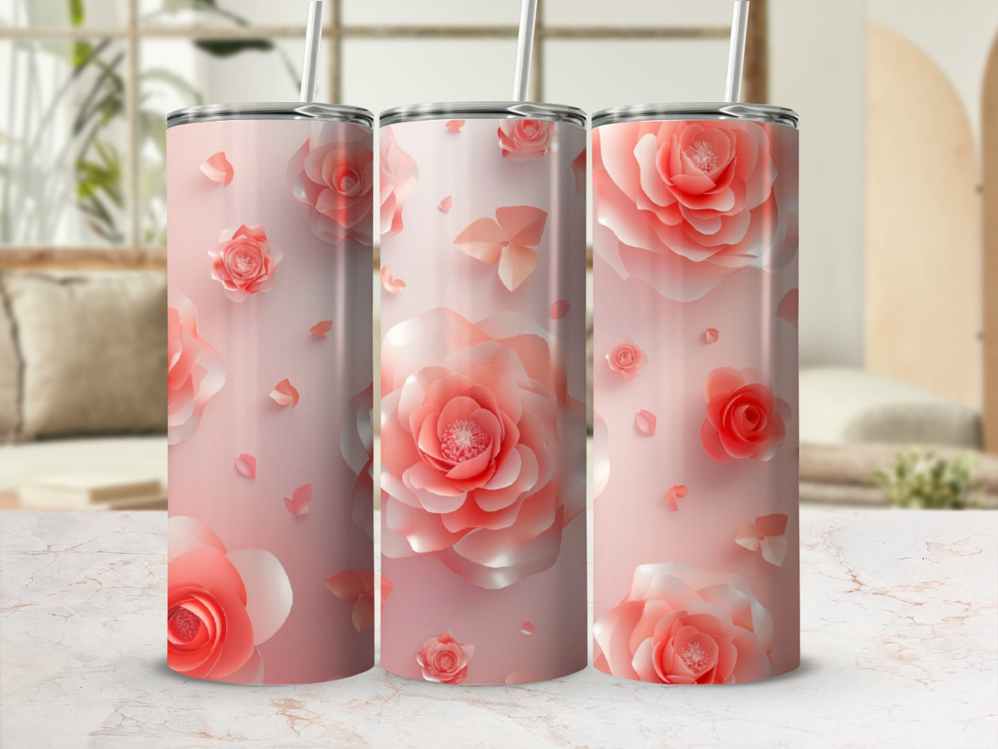 Pink and peach floral pattern on three stainless steel tumblers.