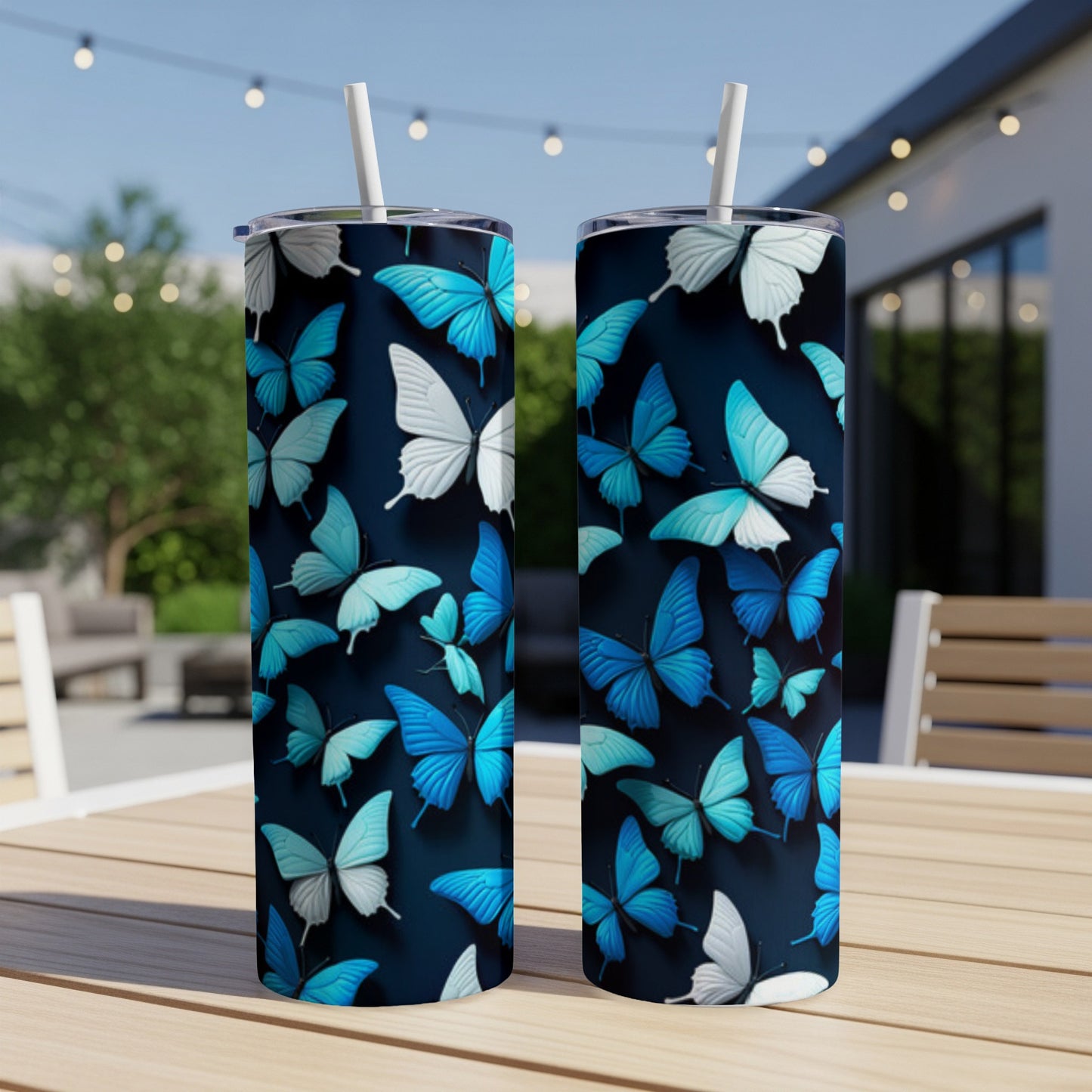 Two tumblers with a blue and white butterfly pattern on a wooden table.