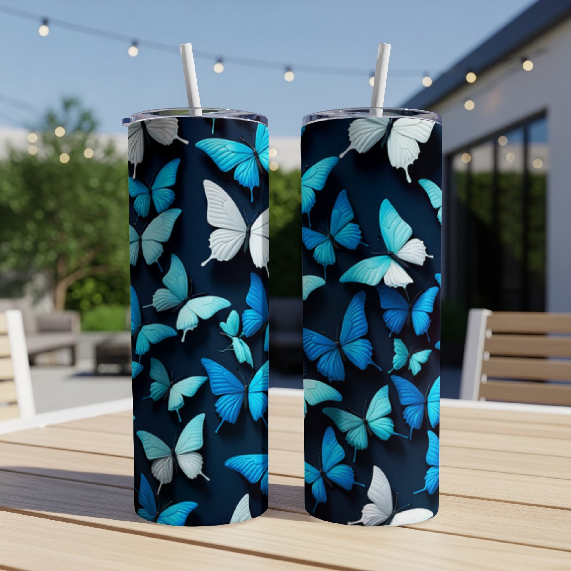 Two tumblers with a blue and white butterfly pattern on a wooden table.