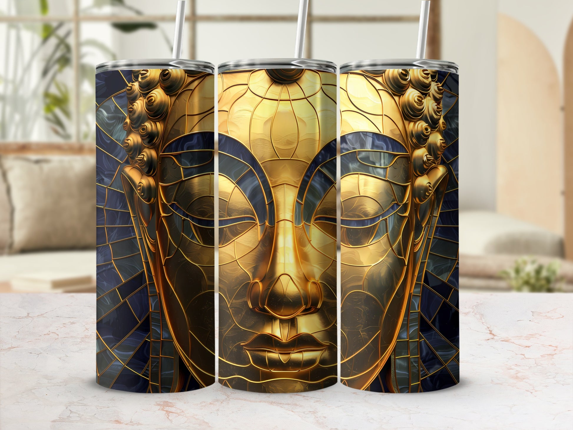 Three tumblers with gold Buddha face design and dark blue mosaic background.