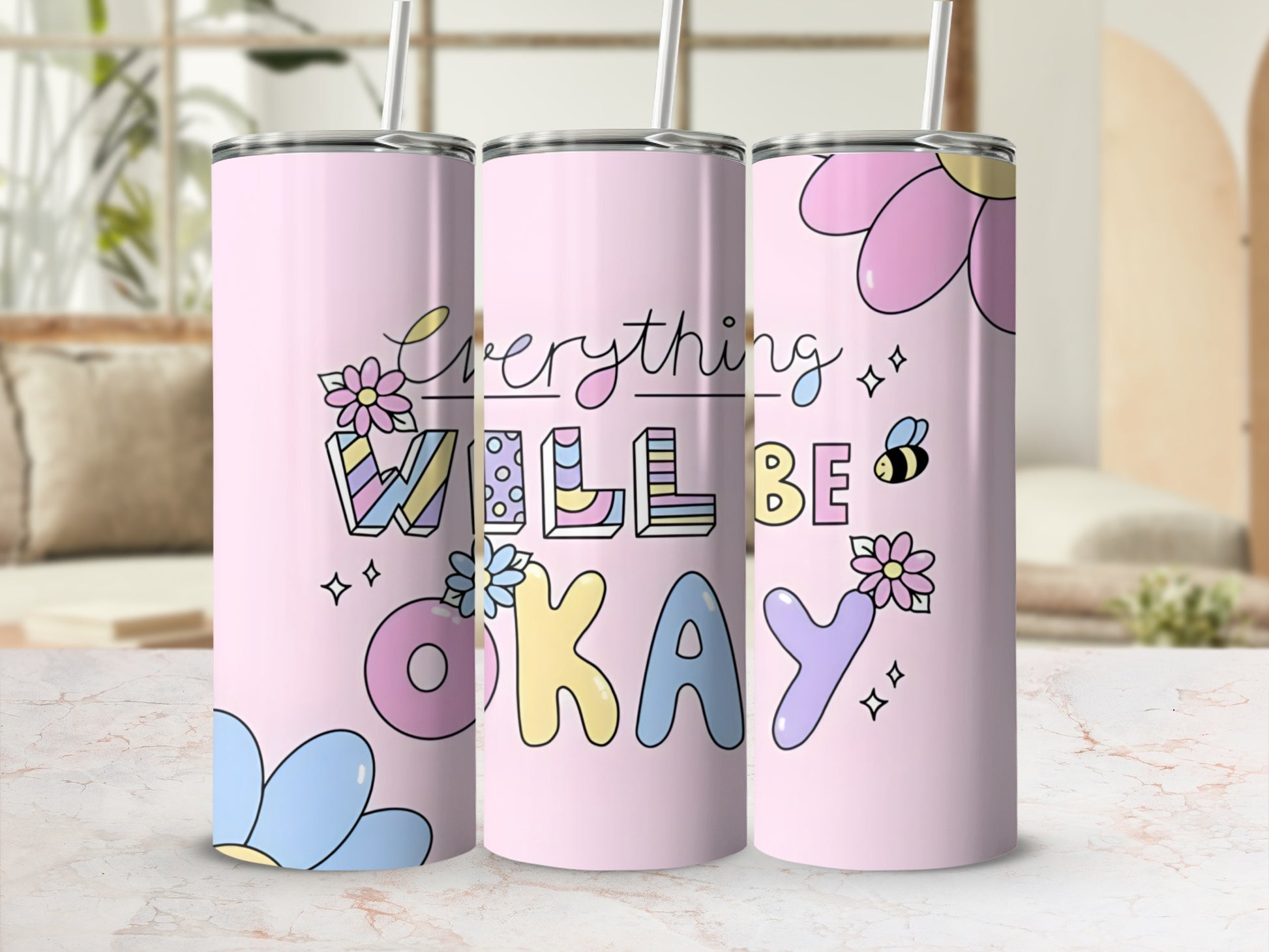 Pink tumbler with "Everything Will Be Okay" text and floral design.