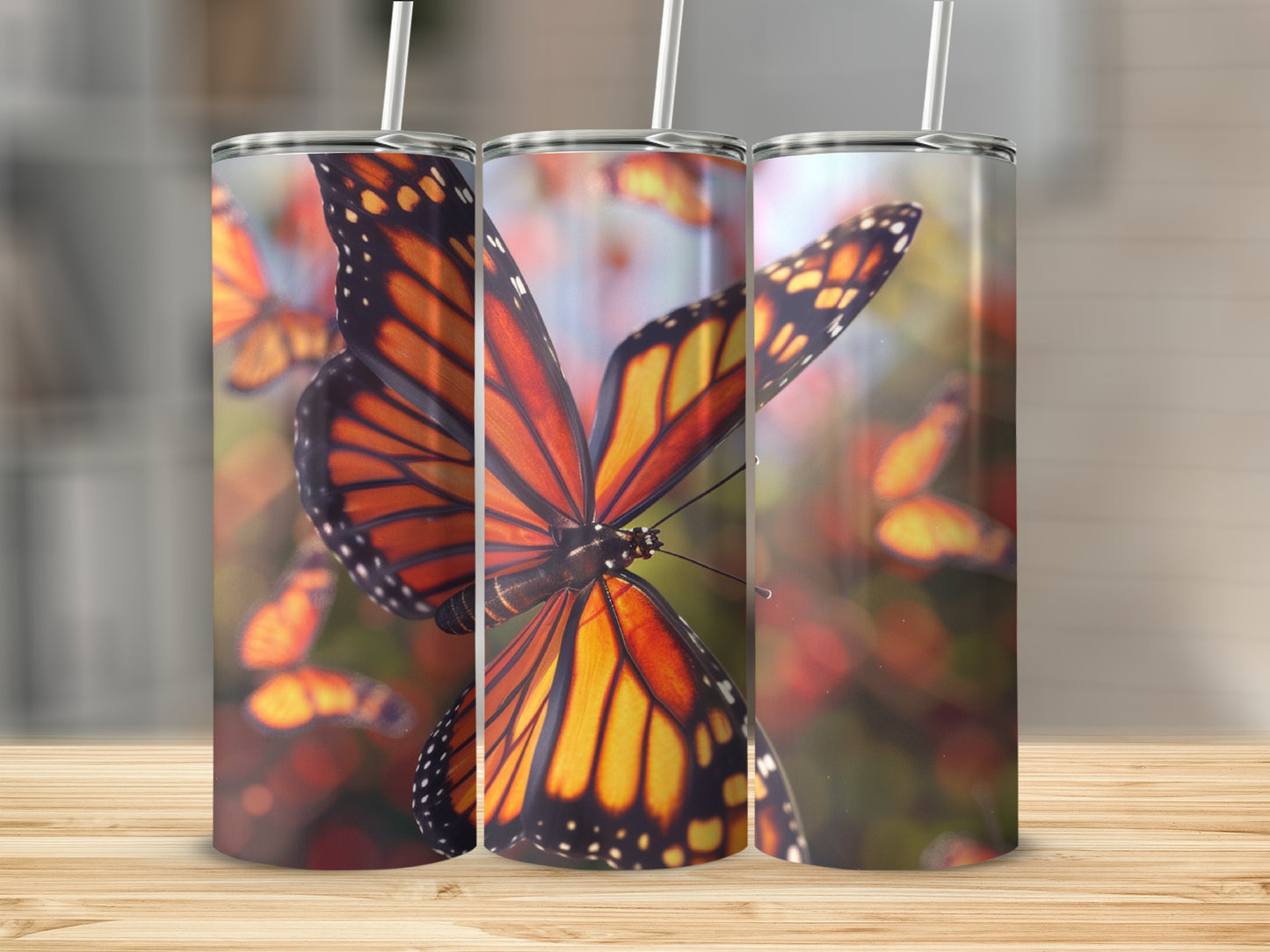 Three monarch butterflies on a tumbler, with bokeh background.