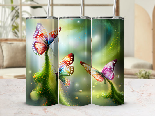 Three tumblers with colorful butterfly designs on a blurred background.