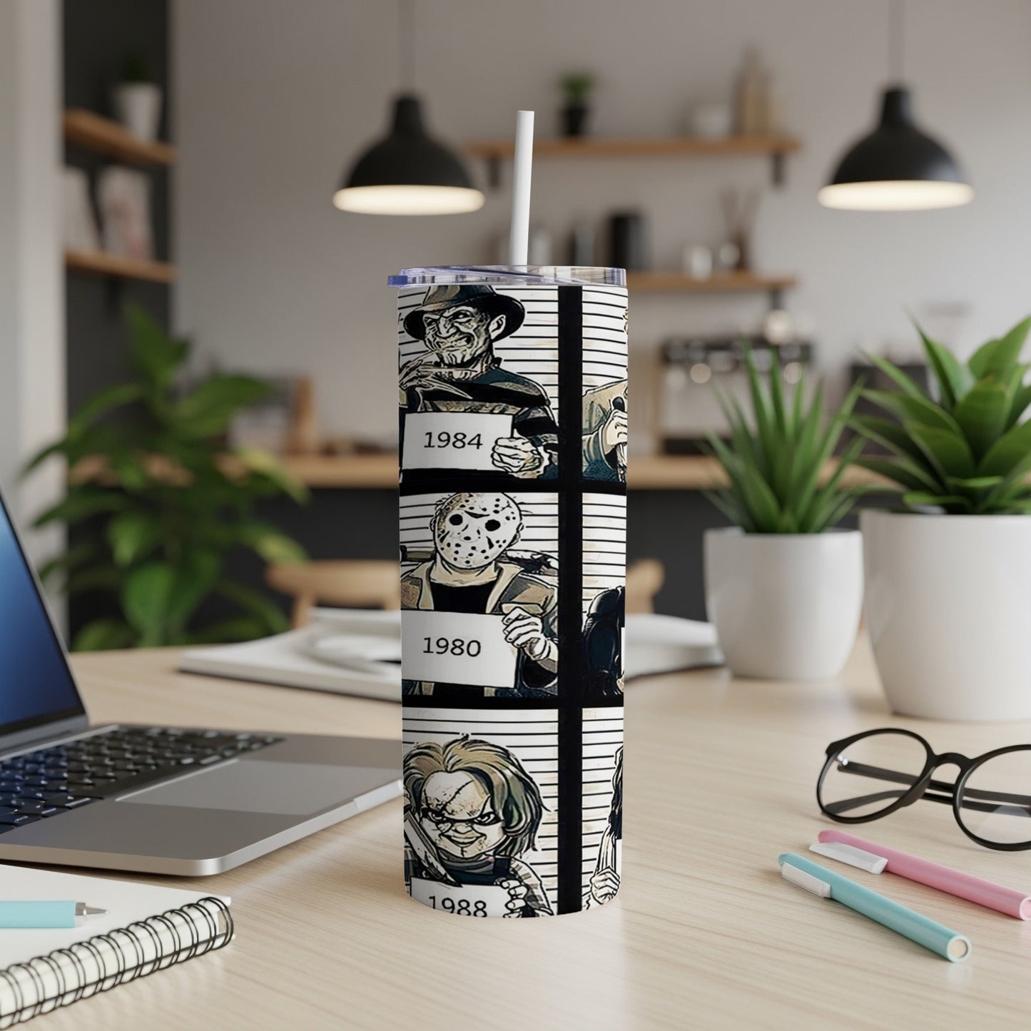 Tumbler with mugshot-style illustrations of horror movie villains and years.