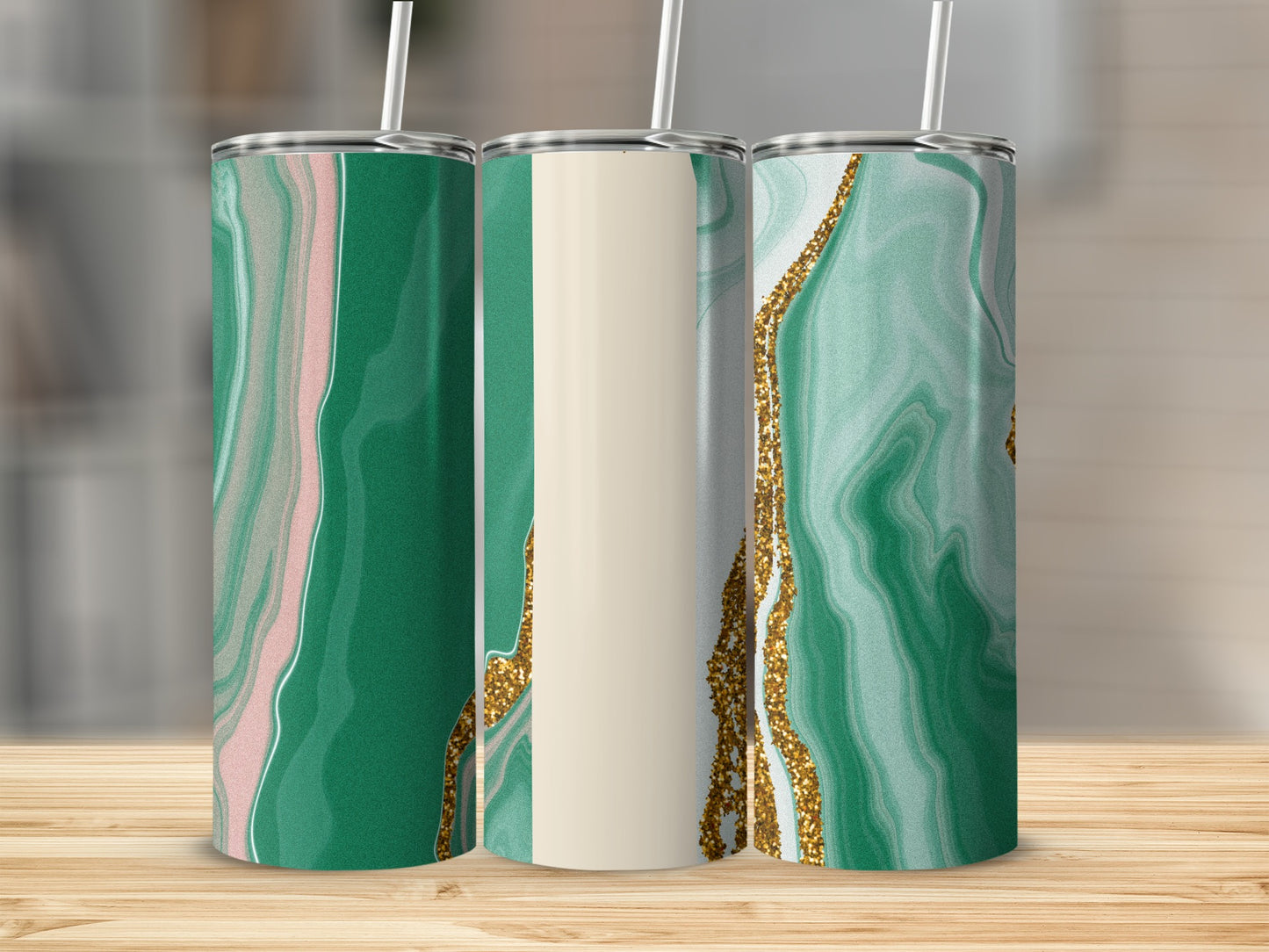 Three green marbled tumblers with gold accents and white straws.