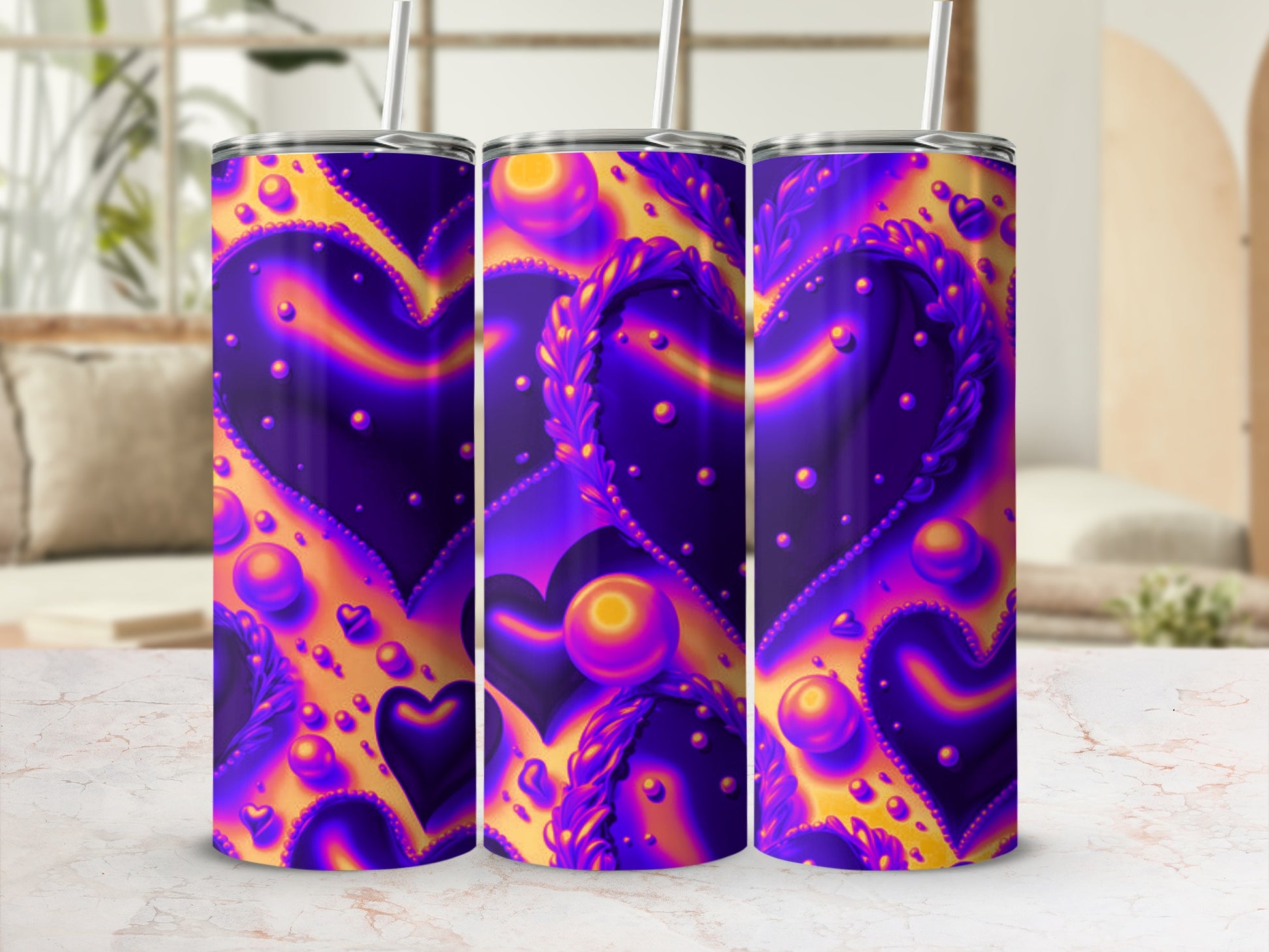 Three purple and gold heart patterned tumblers with straws.