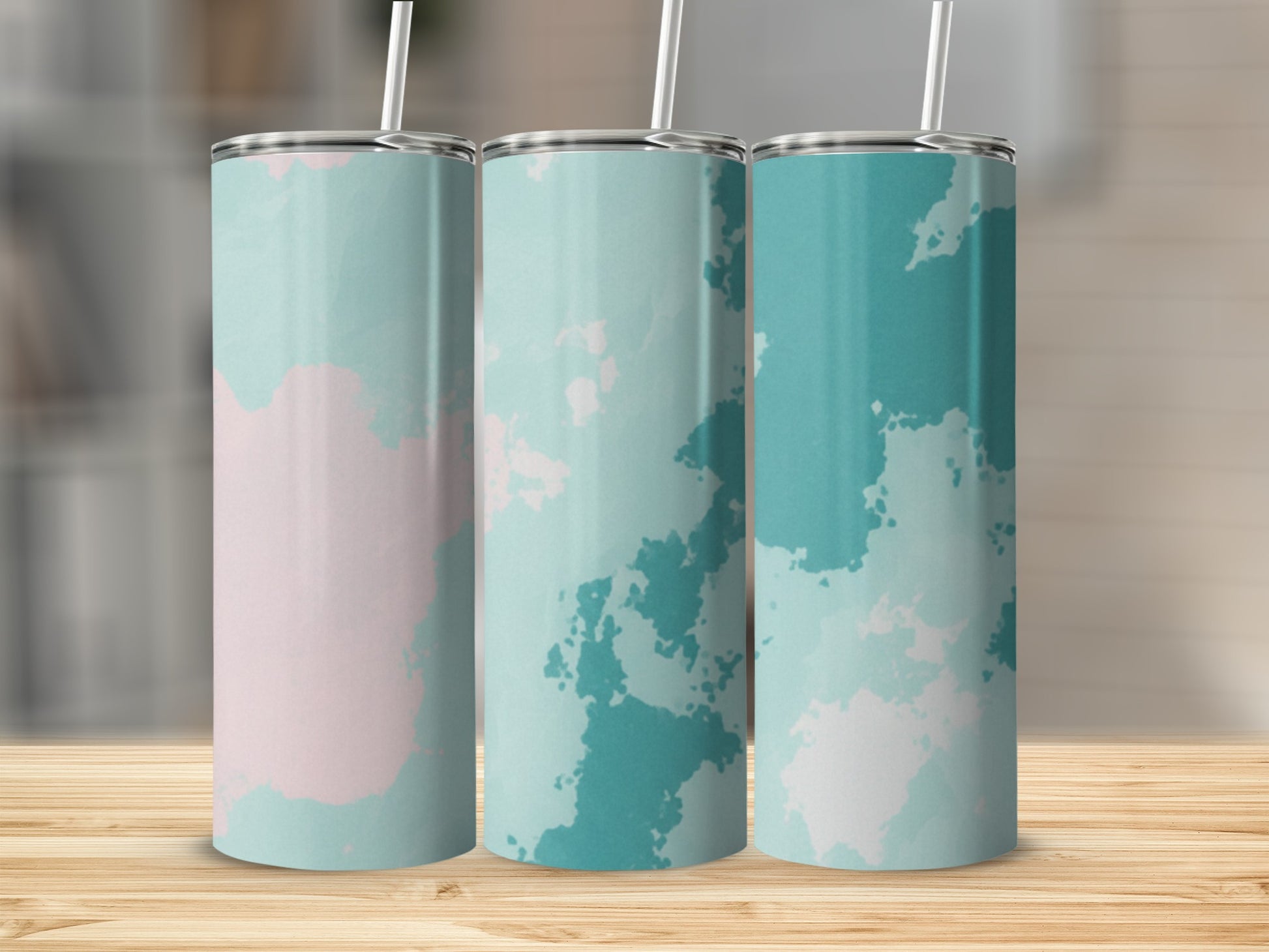 Three tall tumblers with a watercolor pattern of pink and teal.