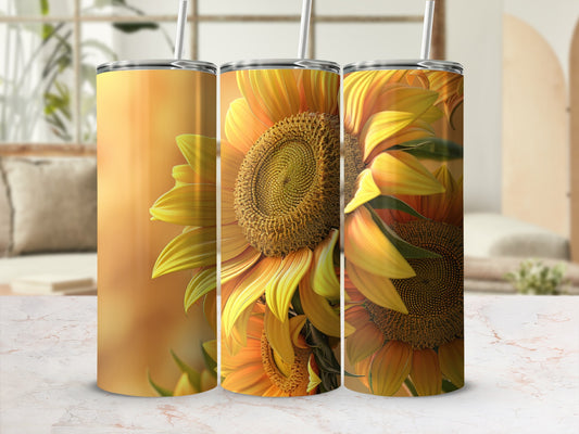 Three sunflowers on tumblers with straw in a bright, airy room.